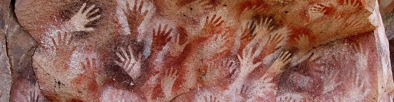 red prints on a cave wall